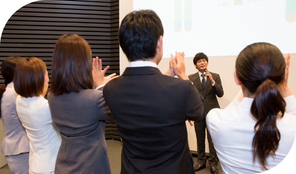 登壇者に拍手をしている写真